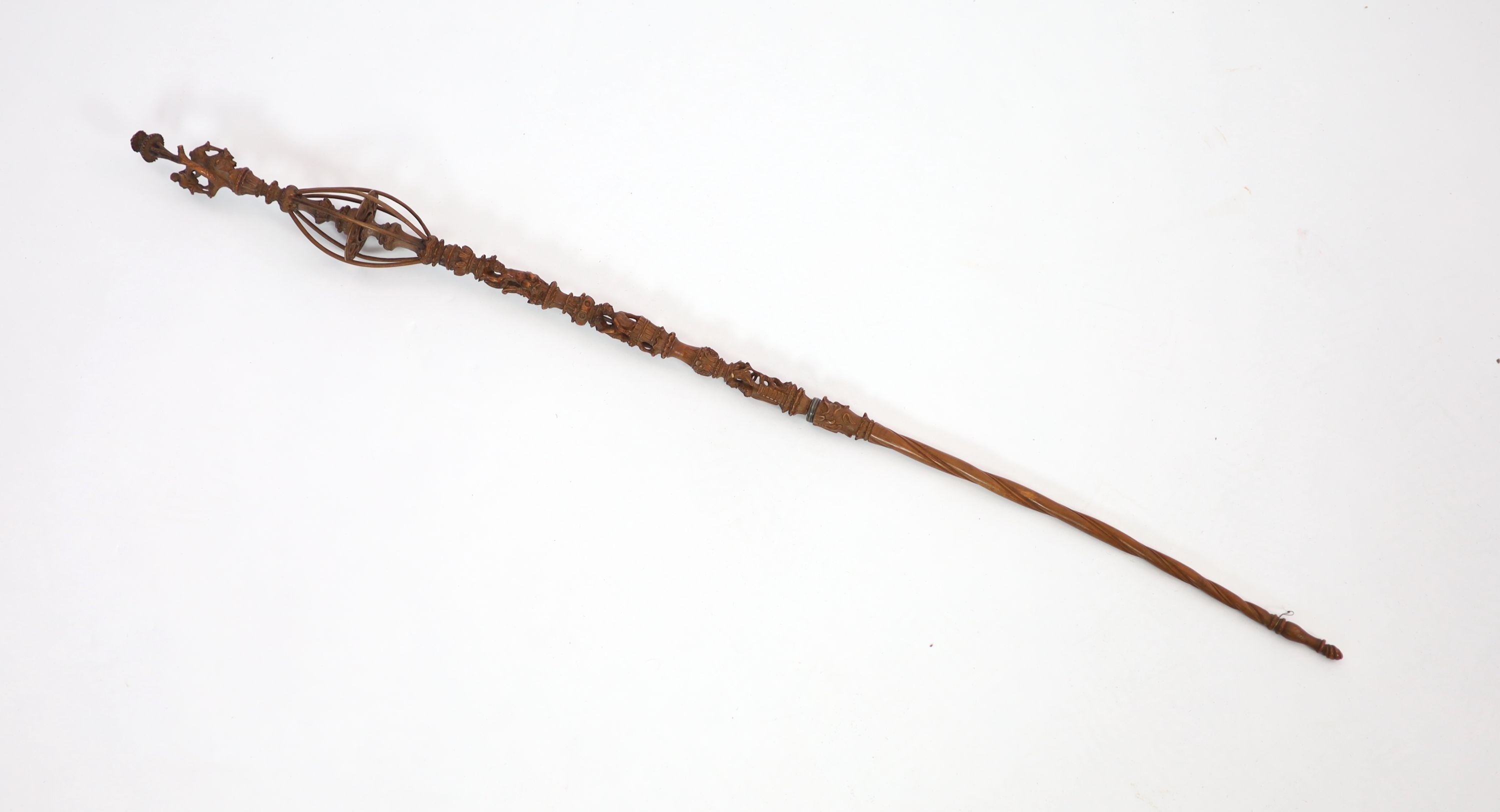 A 17th century French boxwood distaff (wool winder), carved with numerous figures and scrolls, over a spiral fluted stem, 49 & 36cm.